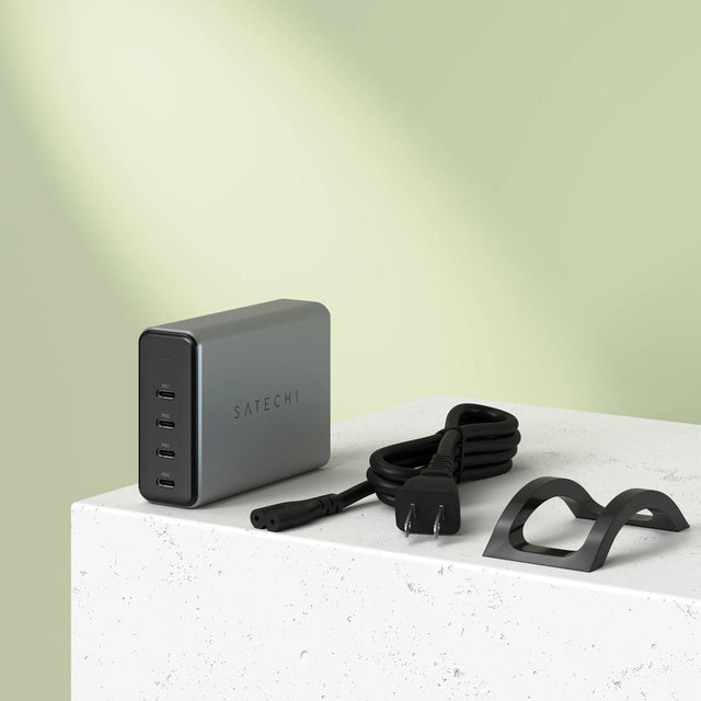 Satechi 165W USB‑C 4‑Port PD GaN Charger shown with its power cable and stand, featuring a compact aluminum design and four USB‑C PD ports.