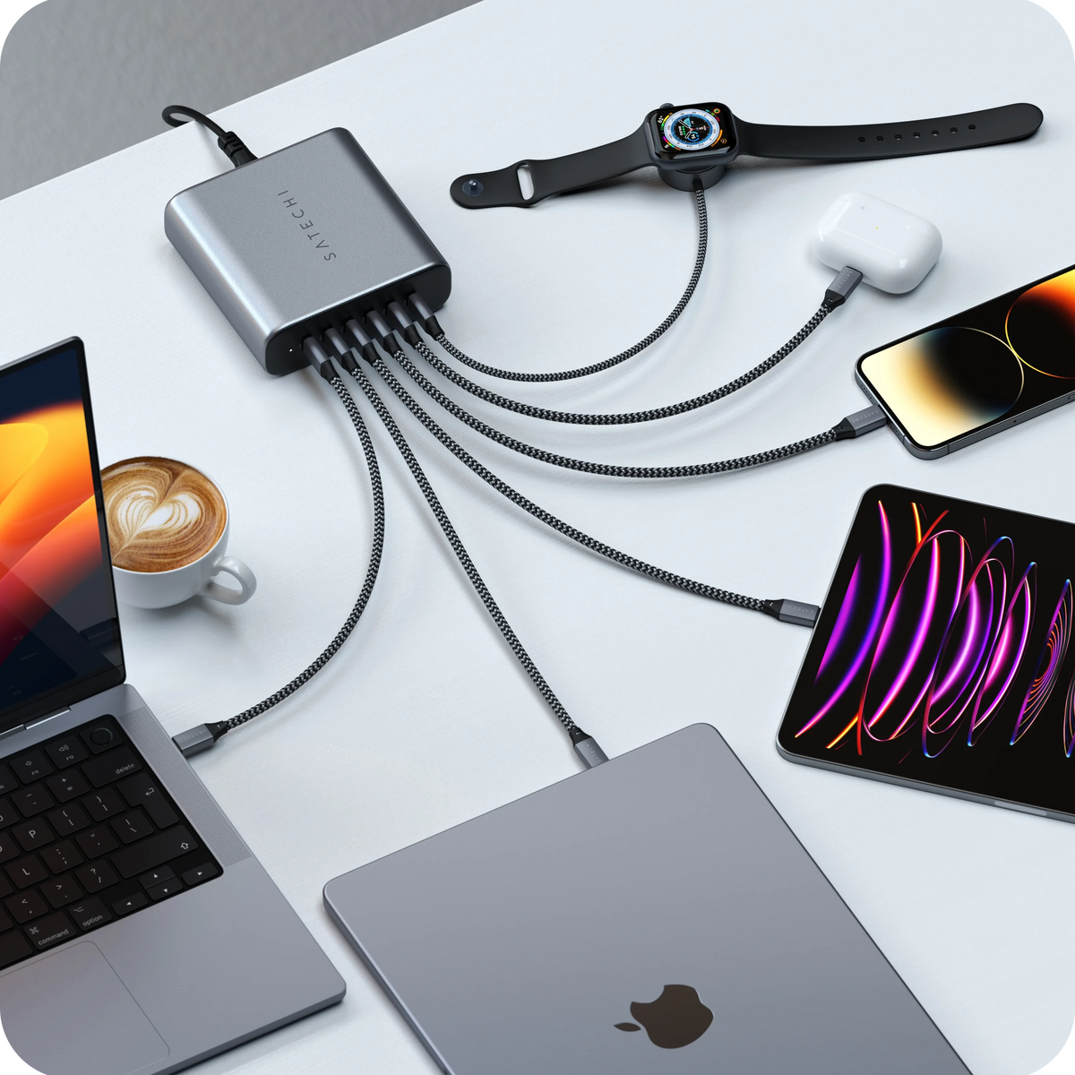 Satechi  200W USB-C 6-Port PD GaN Charger charging multiple devices at once, including MacBook, iPad, Apple Watch,  Laptop, iPhone, and AirPods.