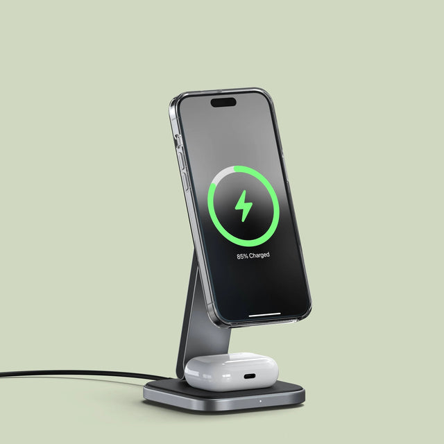 Satechi 2-in-1 Foldable Qi2 Wireless Charging Stand charging an iPhone and AirPods.
