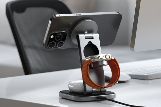 Satechi 3-in-1 Foldable Qi2 Wireless Charging Stand with iPhone, Apple Watch, and AirPods on a desk.
