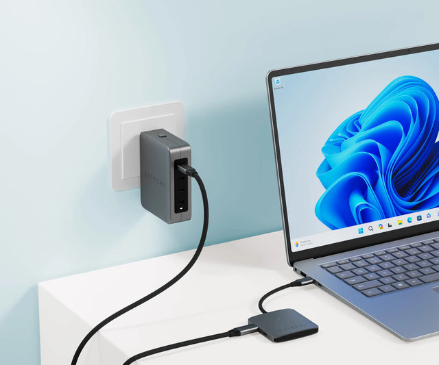 Satechi 4‑Port USB‑C Hub with Power Delivery connected to a laptop and powered by a Satechi wall charger, demonstrating 100W max for USB‑C devices.