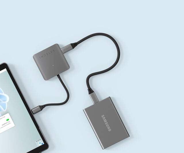 Satechi 4‑Port USB‑C Hub with Power Delivery connected to an iPad and an external Samsung SSD, showing multiple USB‑C ports supporting data transfer.