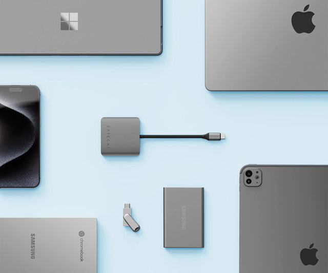 Satechi 4‑Port USB‑C Hub with Power Delivery displayed among laptops, tablets, smartphones, and portable SSDs, emphasizing broad compatibility with USB‑C devices.