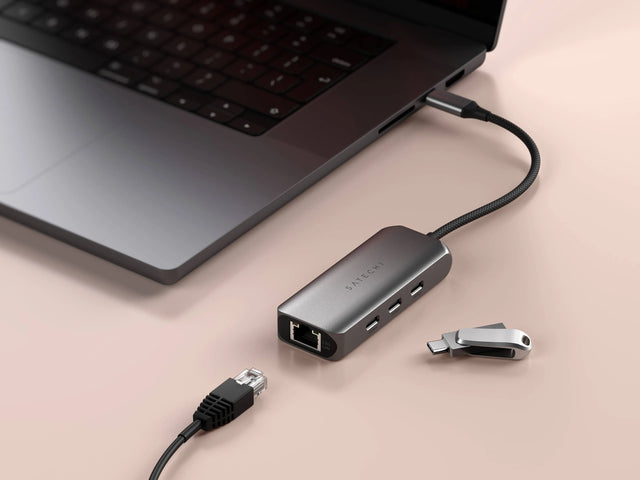 Close‑up of the Satechi 4‑in‑1 USB‑C Hub with 2.5 Gigabit Ethernet connected to a laptop, demonstrating high‑speed wired network support.