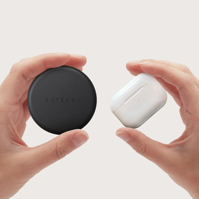 Two hands holding a OntheGo™ 7-in-1 Multiport Adapter and a pair of AirPods to show similar size. 