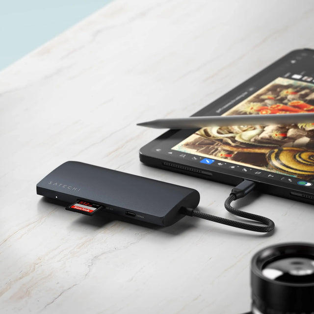 Satechi USB‑C Multiport Adapter 8K With Ethernet V3 plugged into an iPad with SD and microSD cards inserted for media transfer.