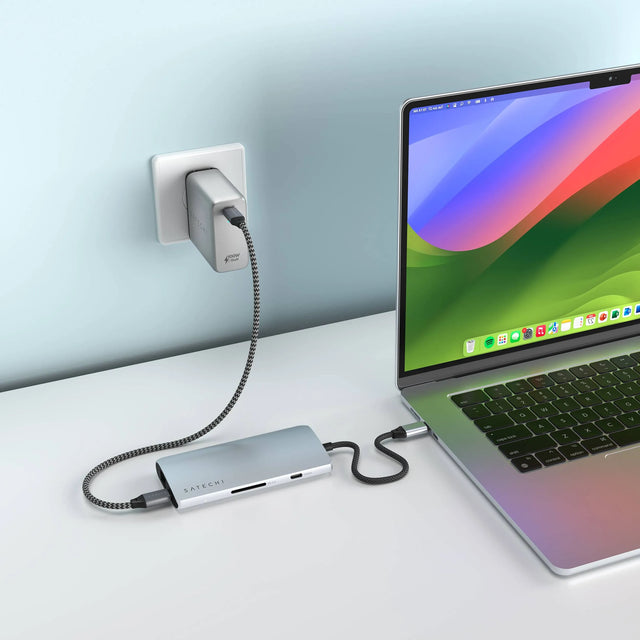 Satechi USB‑C Multiport Adapter 8K With Ethernet V3 connected to a MacBook, displaying pass‑through charging and multiple ports.