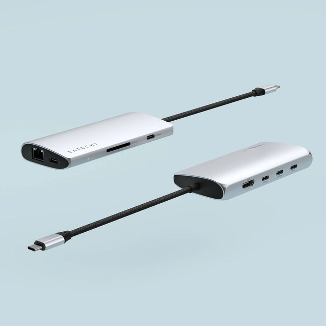 Two angled views of the Satechi USB‑C Multiport Adapter 8K With Ethernet V3 showing its Ethernet port, card reader slots, USB‑C, and HDMI ports.