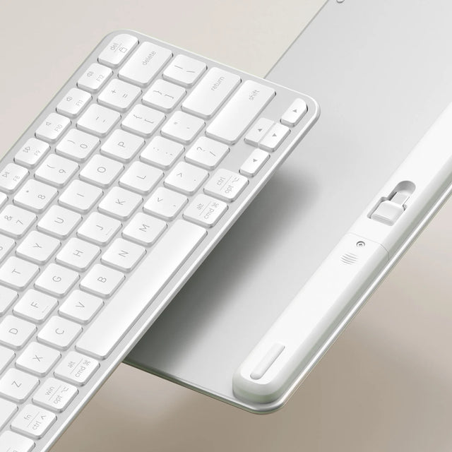 A closeup of front and back of a Slim EX1 Wireless Keyboard, showing the 2.4GHz dongle.