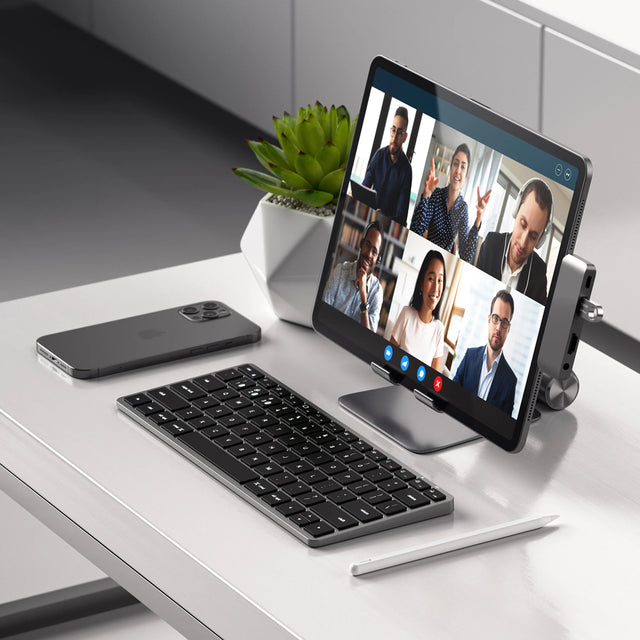 iPad with video call on screen connected to a Satechi Slim X1 Bluetooth Backlit Keyboard.