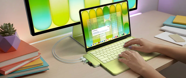 A Citrus MacBook Neo with a matching Satechi USB-C Snap Hub in Citrus attached and displaying onto second external iMac monitor.