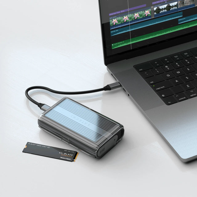 Satechi USB4 NVMe SSD Pro Enclosure connected to a laptop via USB‑C demonstrating video editing workflow, massive video storage capability, with an NVMe drive placed nearby.