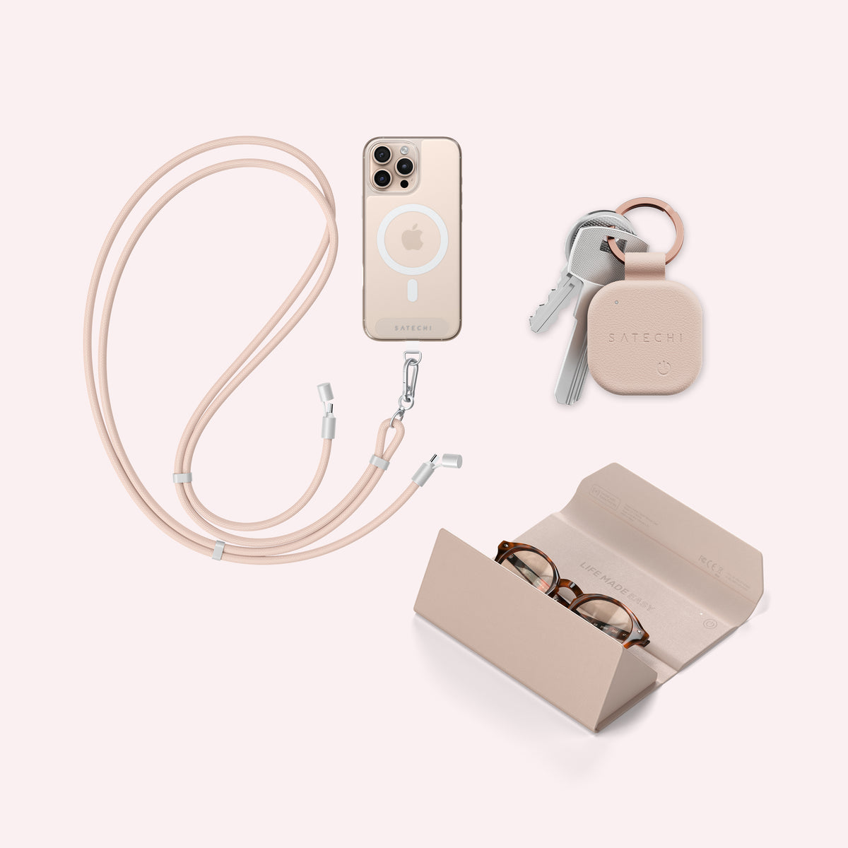 The Campus Carry back-to-school bundle: a FindAll keychain clipped to a set of keys, a Desert Rose OntheGo crossbody phone lanyard cable with MagSafe, and a Desert Rose FindAll glasses case holding a pair of glasses, arranged on a pale pink background.