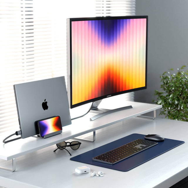 Satechi Dual Vertical Laptop Stand storing a MacBook and iPhone vertically beside an external monitor in a clean, minimalist workspace.