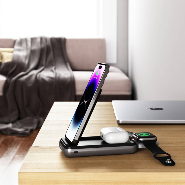 Side view of the Satechi Duo Wireless Charger Power Stand charging an iPhone, AirPods, and an Apple Watch a home desk.