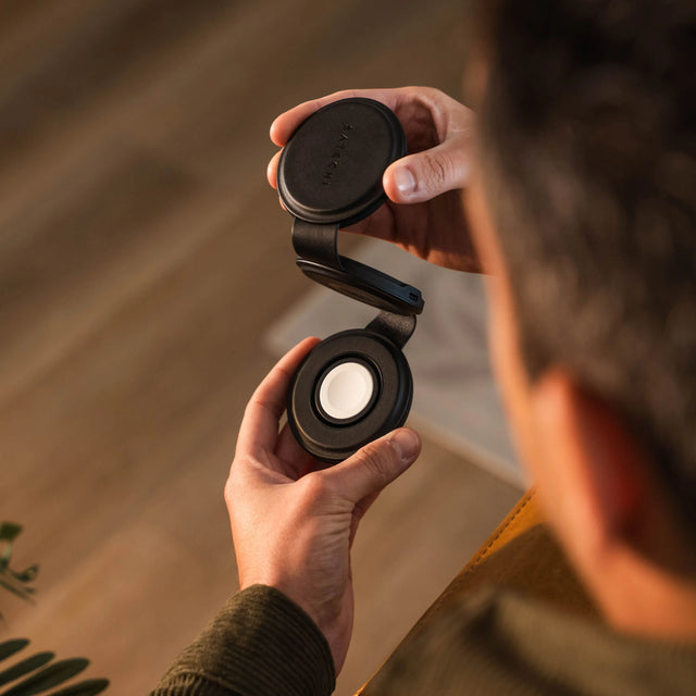A person unfolding a OntheGo™ 3-in-1 Charger to show three platform design.