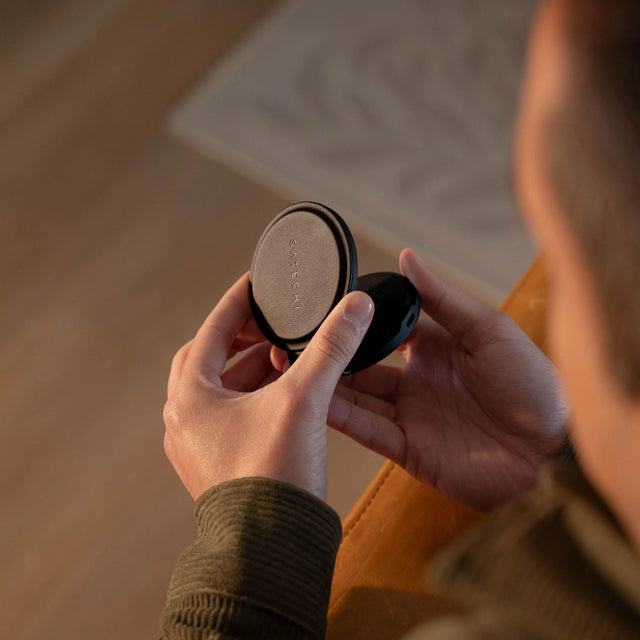 A person unfolding a OntheGo™ 2-in-1 Charger to show three platform design.
