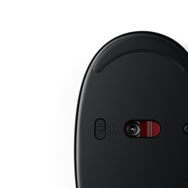 Bottom view of the M1 Wireless Mouse showing the optical sensor and on/off switch for power control.