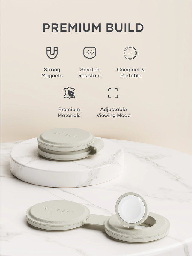 Two OntheGo™ 2-in-1 Chargers on a marble platform, one folded and one laid out flat, with the words Premium Build, strong magnets, scratch resistant, compact and portable, premium materials, and adjustable viewing mode, placed nearby. 