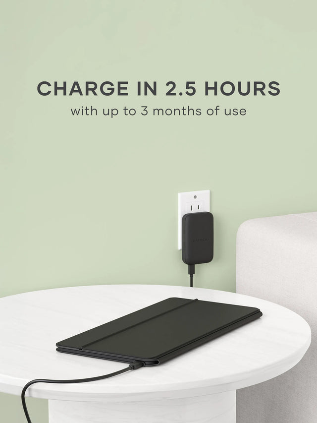The OntheGo™ Bluetooth Keyboard with Stand on white surface while being charged by the OntheGo™ 67W Slim Wall Charger. Text says " Charge in 2.5 Hours with up to 3 months of use"