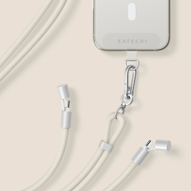 iPhone with a Satechi OntheGo™ USB-C Lanyard Cable connected to clear case on a beige background.