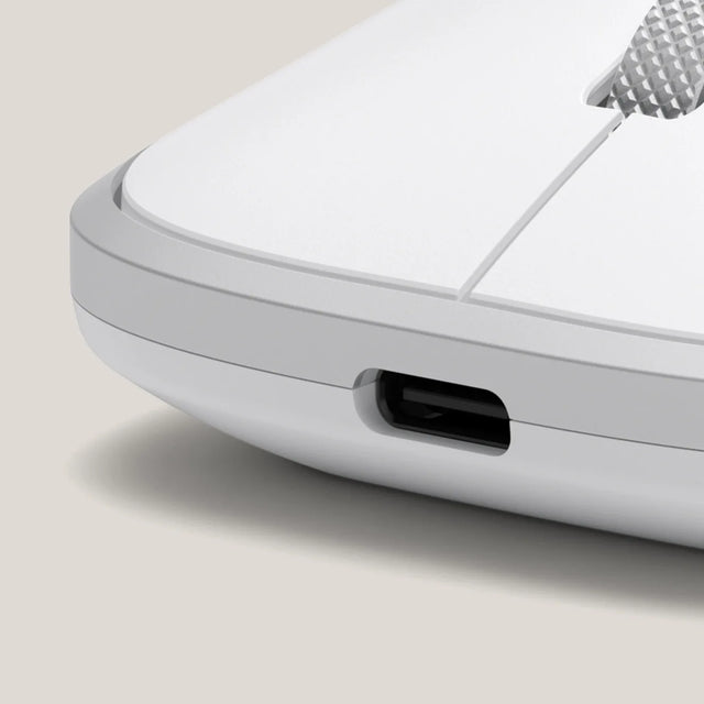 Extreme close-up of the Satechi Slim EX Wireless Mouse in Silver, showing the USB-C charging port set into the front edge and the knurled scroll wheel above it. Macro detail highlighting the USB-C rechargeable design of the silent wireless mouse.