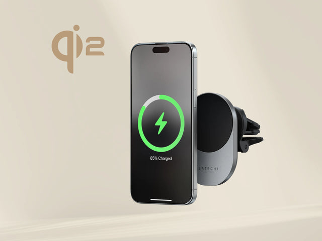 iPhone floating near Satechi Qi2 Wireless Car Charger mounted on a car vent, displaying an 85% charging status.