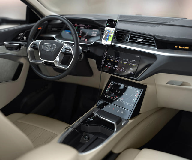 Satechi Qi2 Wireless Car Charger holding a iPhone in portrait mode for charging and in landscape mode for GPS navigation inside a vehicle.