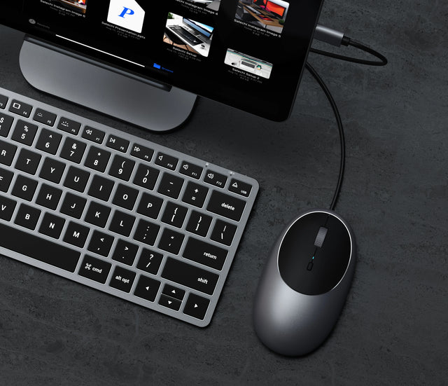 Satechi C1 USB‑C Wired Mouse with an ergonomic design and USB‑C connectivity, shown on a dark desktop setup beside a keyboard.