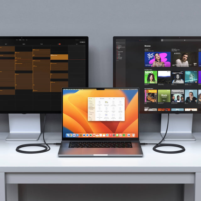Laptop with two monitors on a desk, connected by two Thunderbolt 4 Pro Cables displaying different applications.