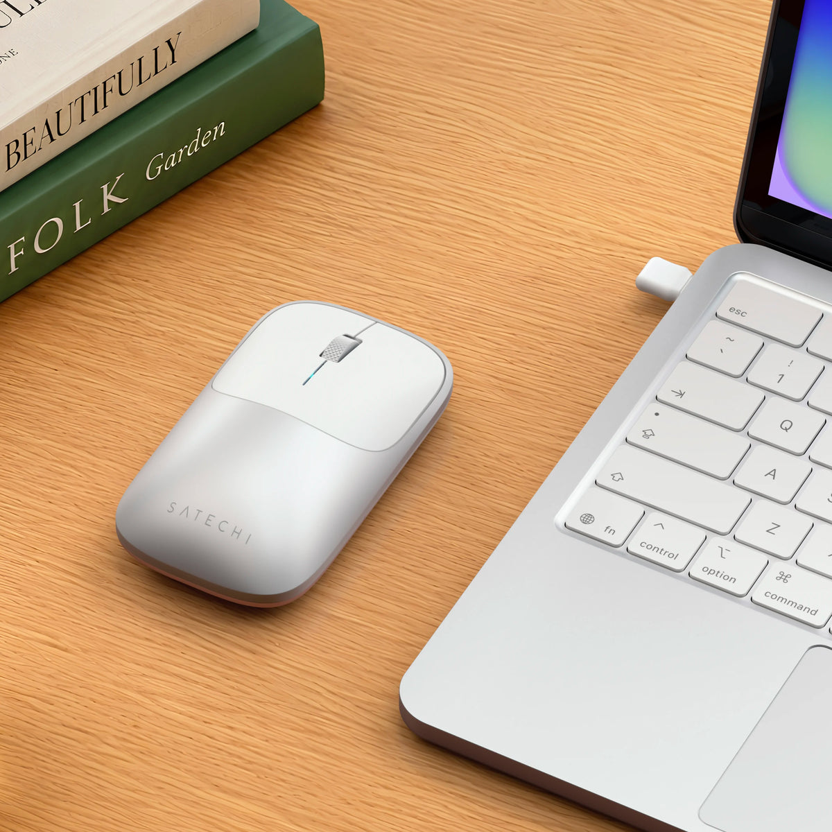 Satechi silver Slim EX Wireless Mouse on desk next to silver MacBook Neo.
