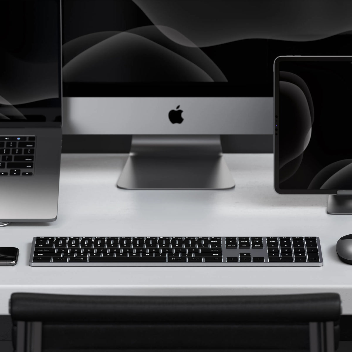 A Satechi Slim X3 Bluetooth Backlit Keyboard paired to a MacBook, iMac, and iPad.