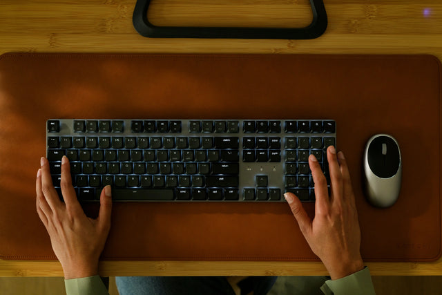 Two hands typing on a SM3 Slim Mechanical Backlit Bluetooth Keyboard, showing the backlight patterns.
