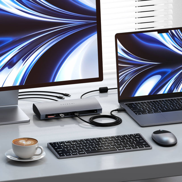 Thunderbolt 4 Dock connected to a MacBook, while displaying a large external monitor. 