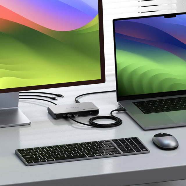 A iMac monitors, a laptop connected by a Thunderbolt 4 Slim Hub Pro, showing multiple display compatibility and compact design. 