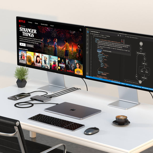 Thunderbolt 4 Slim Hub Pro connecting a MacBook to  dual monitors displaying 'Stranger Things' and a code editor, while charging an iPhone simultaneously.