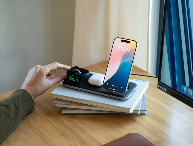 Satechi Qi2 Trio Wireless Charging Pad charging an iPhone, Apple Watch, and AirPods on top of desk.