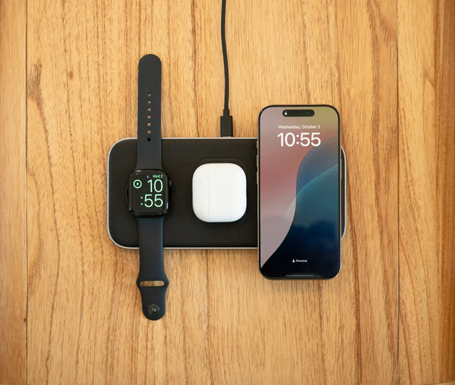 A top down look of the the Satechi Qi2 Trio Wireless Charging Pad charging an iPhone, Apple Watch, and AirPods on top of desk.
