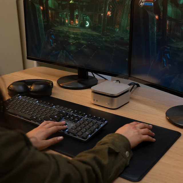 Satechi USB4 Slim NVMe SSD Enclosure placed beside a dual‑monitor gaming setup, shown supporting fast transfer speeds ideal for storing and accessing large gaming libraries.