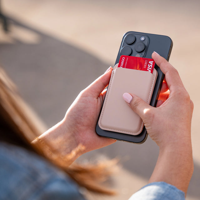 Person holding a phone with Vegan-Leather Magnetic Wallet Stand, showcasing card slot and credit card.
