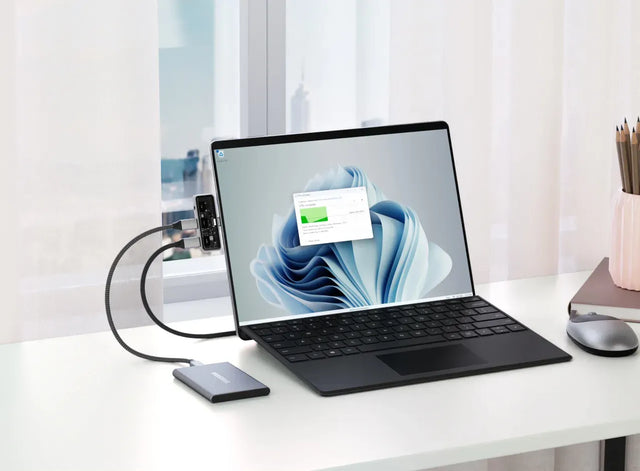 Satechi Mobile XR Hub with Audio connected to a MacBook while the user navigates device settings, demonstrating smooth file access and fast data transfer.